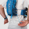 Close up of man wearing Ultimate Direction Mountain Vest 5.0, pulling rear adjustment cords