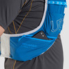 Close up of man wearing Ultimate Direction Mountain Vest 5.0, showing phone partially extending from storage pocket on shoulder strap