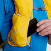Close up of man placing phone in pocket of Ultimate Direction Fastpack 20