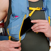 Close up of man placing phone in pocket of Ultimate Direction Fastpack 30