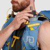 Close up of man placing water bottle in pocket of Ultimate Direction Fastpack 30