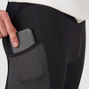 Close up of man wearing Ultimate Direction Men's Hydro Tight, showing man putting phone in thigh pocket