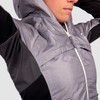 Close up of Woman wearing Ultimate Direction Women's Ventro Jacket, showing ventilation panels under arms
