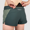 Close up of Ultimate Direction Women's Stratus Short, showing woman placing phone in pocket