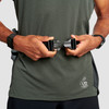 Man wearing Ultimate Direction Access 500, front view, fastening waist belt buckle