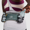 Woman wearing Ultimate Direction Access 600, rear view, pulling bottle from pocket