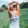 Woman wearing Ultimate Direction Women's Cirrus Singlet, with arms raised above her head
