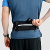 Man wearing Ultimate Direction Comfort Belt Plus, rear view, pulling phone from pocket