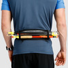 Man wearing Ultimate Direction Comfort Belt, rear view, with trekking poles attached to belt