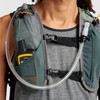 Close up of man wearing Ultimate Direction Highland Vest, showing pockets and hydration tube 2
