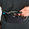 Close up of man wearing Ultimate Direction Race Belt, pulling keys from pocket