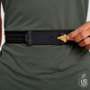 Close up of man wearing Ultimate Direction Race Belt, pulling key from pocket
