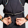 Close up of man wearing Ultimate Direction Race Vest, cinching bungee cord