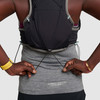 Close up of woman wearing Ultimate Direction Race Vesta, cinching the bungee cord