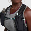 Close up of woman wearing Ultimate Direction Race Vesta, showing water bottles