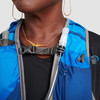 Close up of woman wearing Ultimate Direction Trail Vest, hydration tube