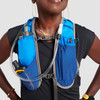 Close up of woman wearing Ultimate Direction Trail Vest, showing pockets and hydration tube