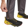 Close up of Man wearing Ultimate Direction Men's Ultra Pant V2, zipping up pant leg