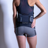 Woman wearing Ultimate Direction Women's Hydro Skin Short, rear view, with hand on hip