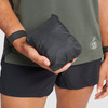 Close up of man holding Ultimate Direction Ultra Pants, stuffed in pocket